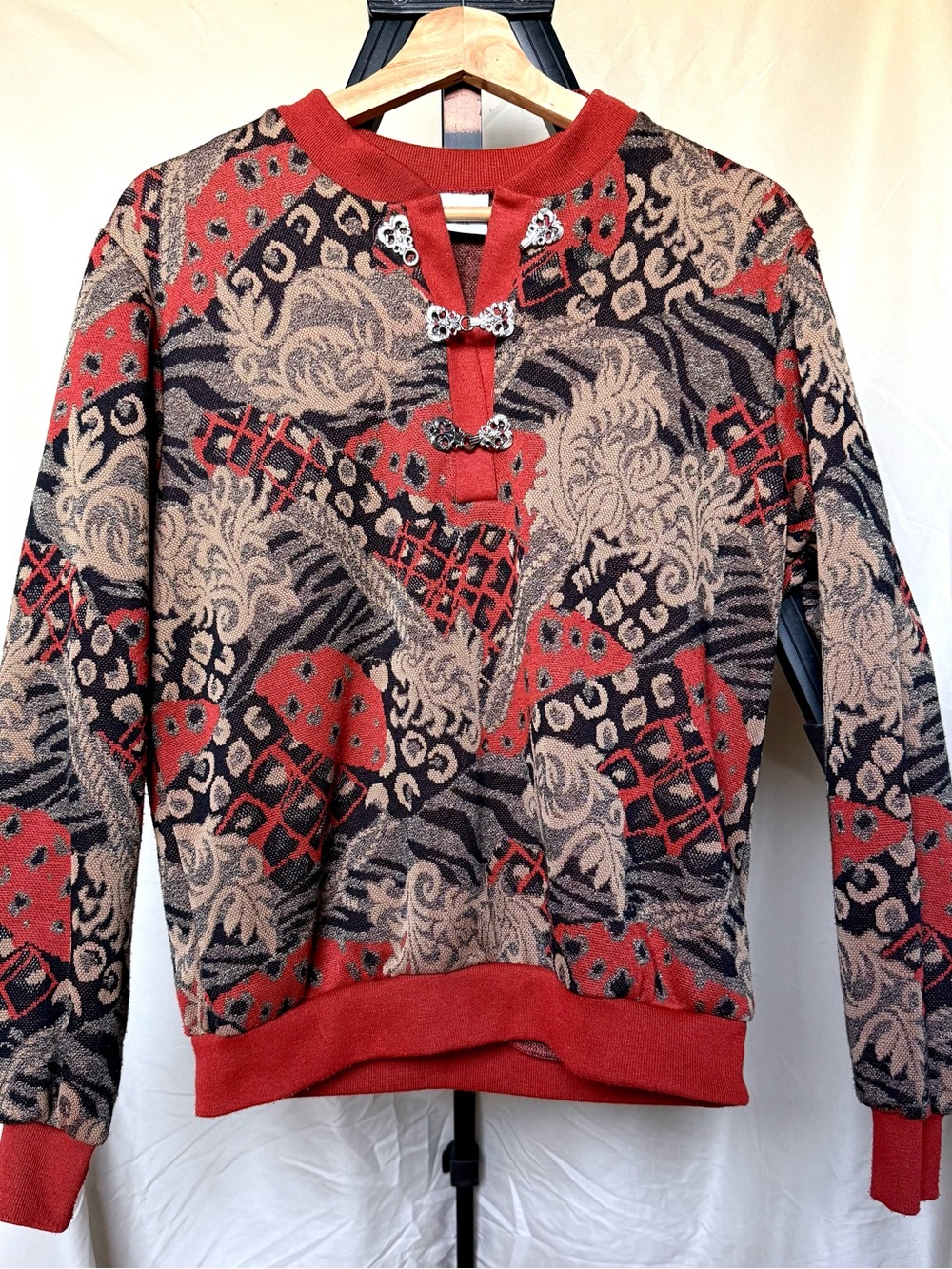Red and Tan Patterned Pullover Sweater with Decorative Clasps